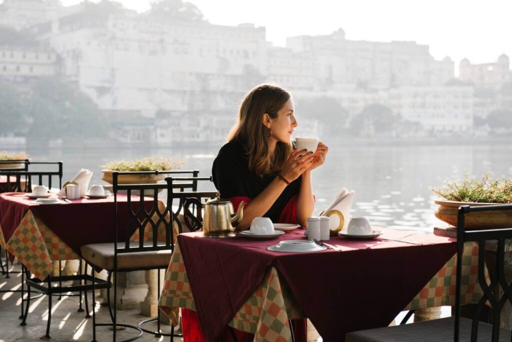 Readers Travel Awards 2023 by Conde Nast Traveller 10 woman-traveller-having-teatime-cafe-udaipur