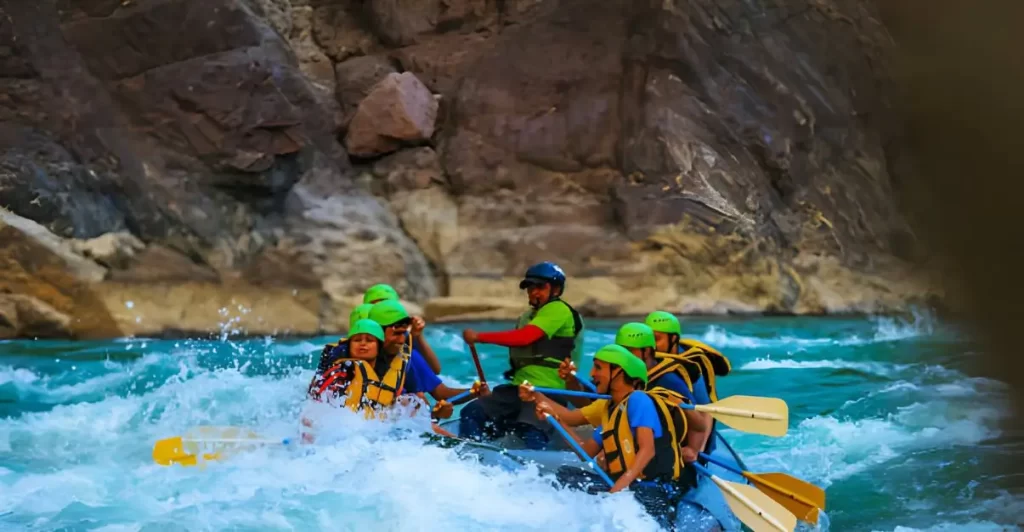 Young people enjoyinh whitewater river rafting in River ganges, Rishikesh India